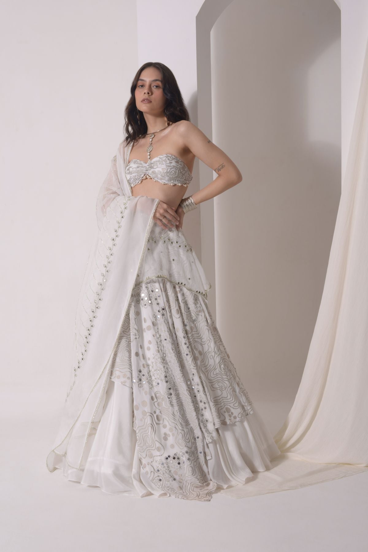 Asymmetrical layered lehenga with foil printed ruched bustier and dupatta