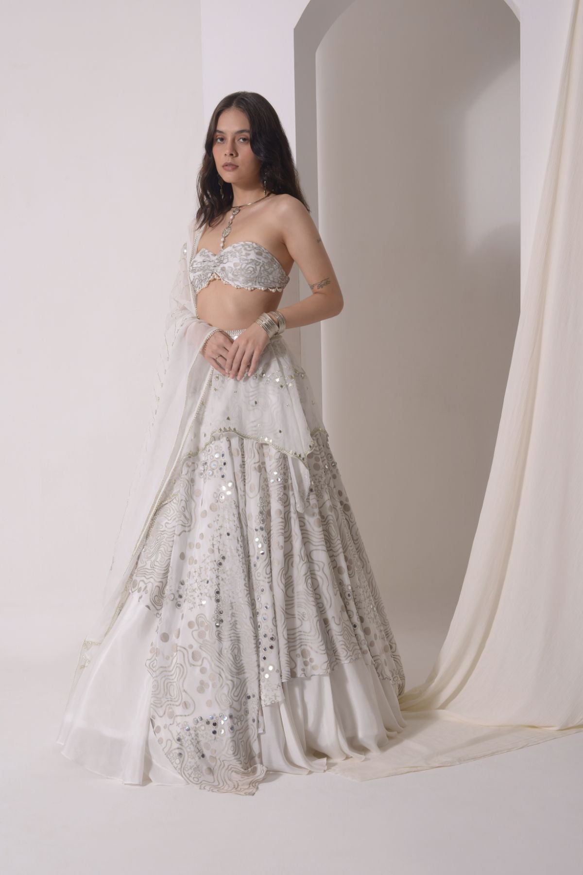 Asymmetrical layered lehenga with foil printed ruched bustier and dupatta