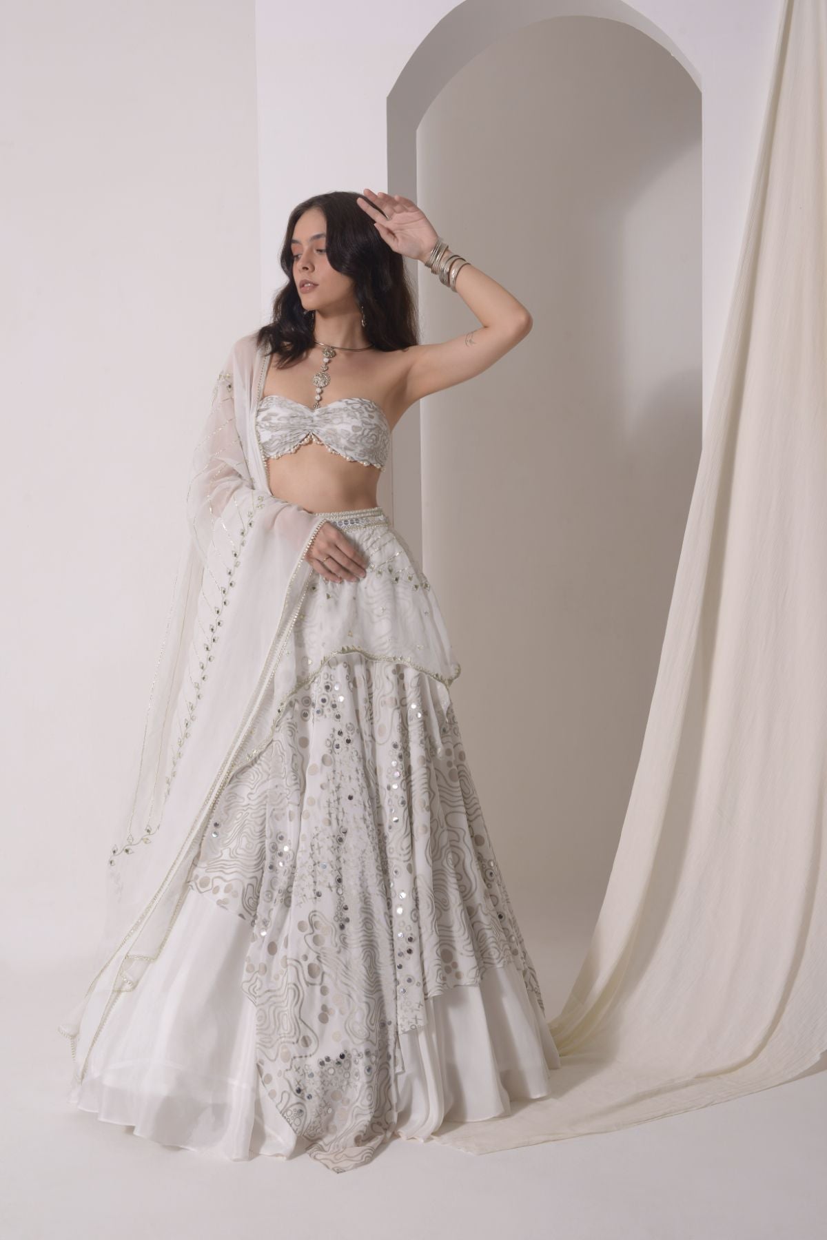 Asymmetrical layered lehenga with foil printed ruched bustier and dupatta
