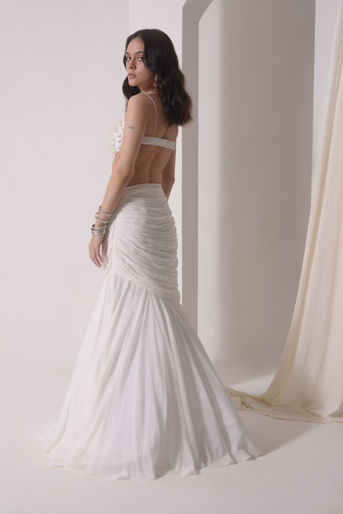 Ruched fish-cut lehenga with beaded bustier and a tulle layered cape