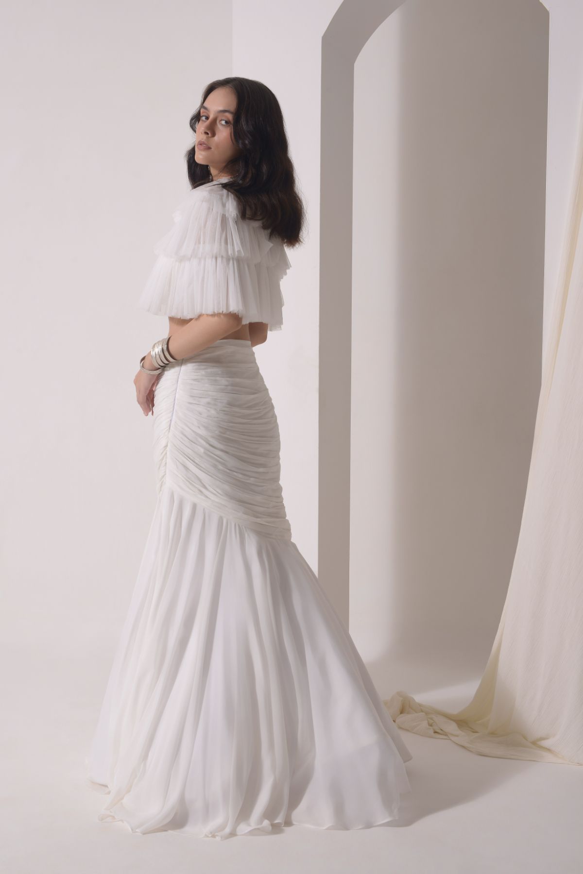 Ruched fish-cut lehenga with beaded bustier and a tulle layered cape