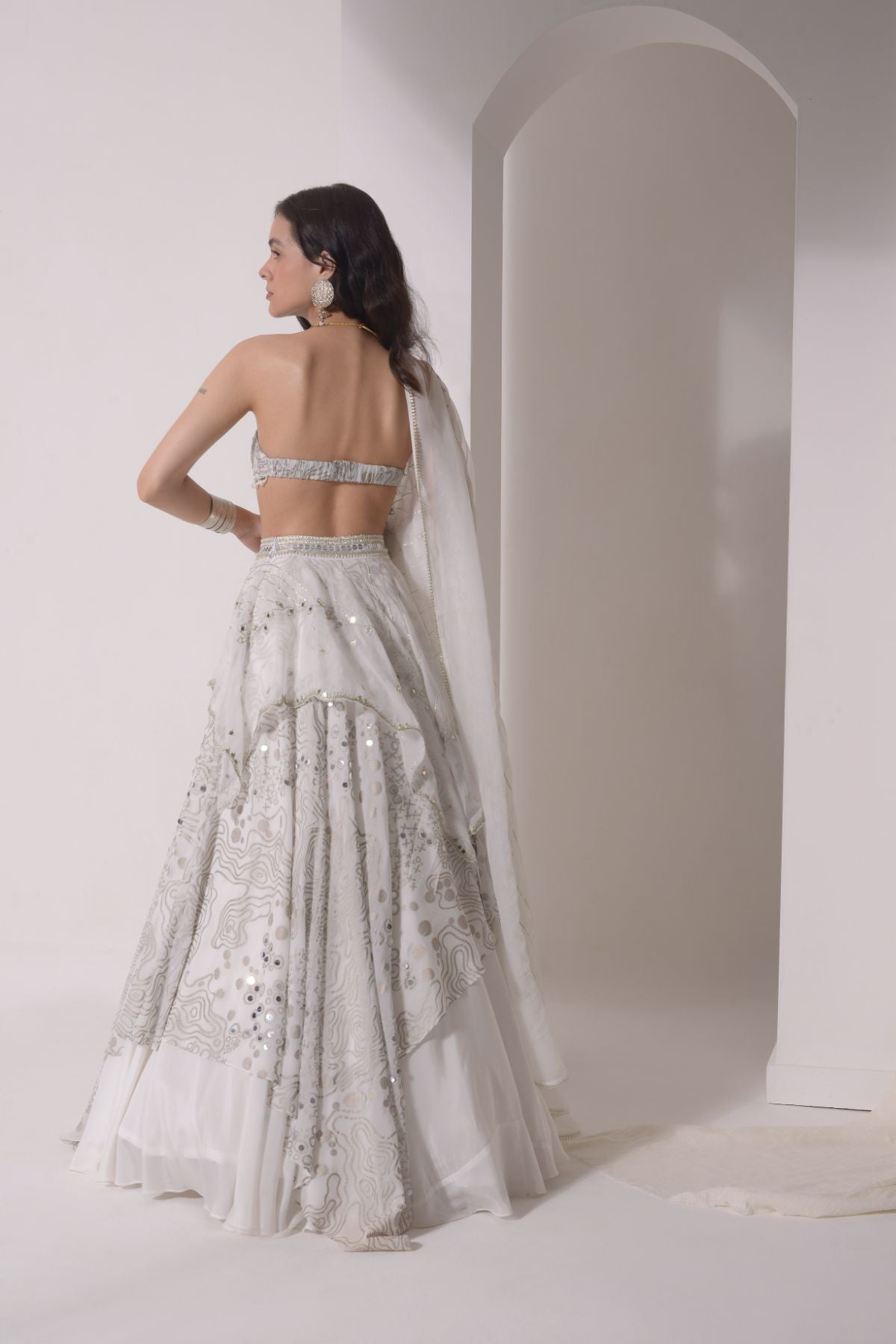 Asymmetrical layered lehenga with foil printed ruched bustier and dupatta