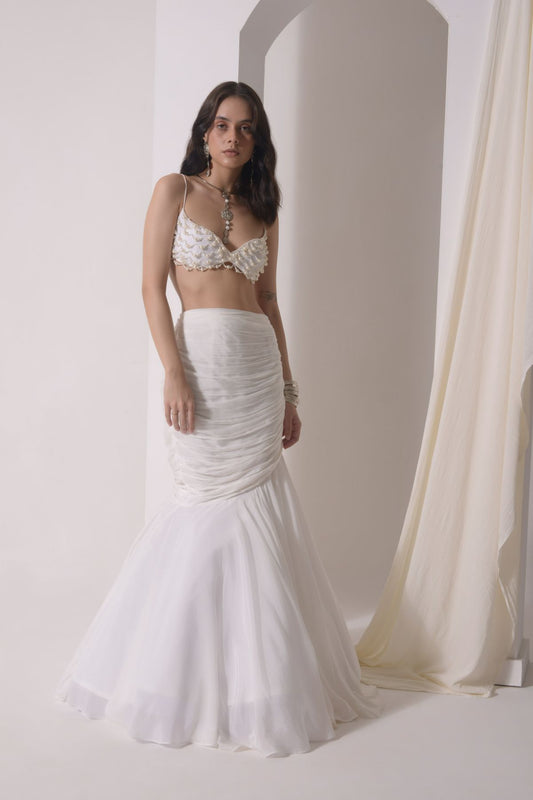 Ruched fish-cut lehenga with beaded bustier and a tulle layered cape