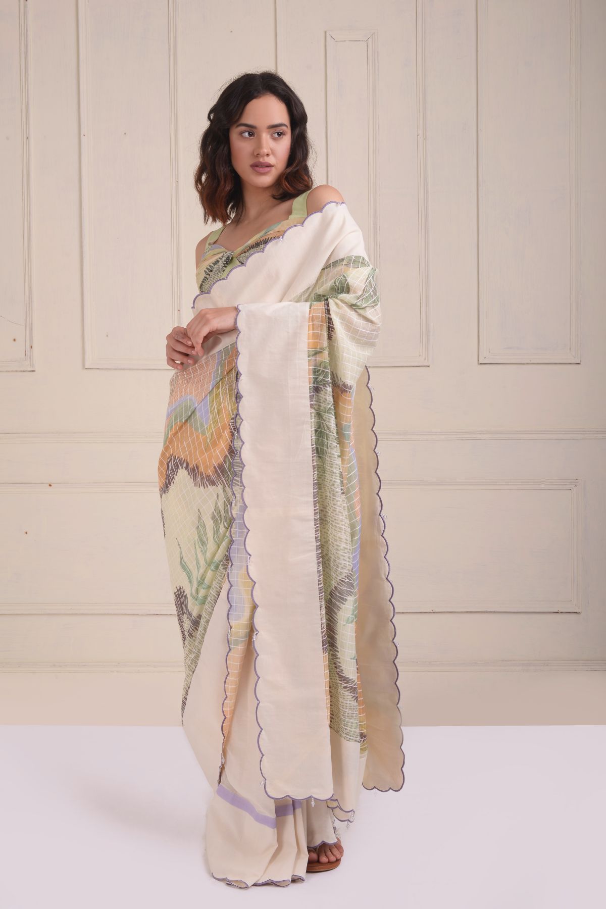 Solid scalloped border printed saree with a printed draped blouse.